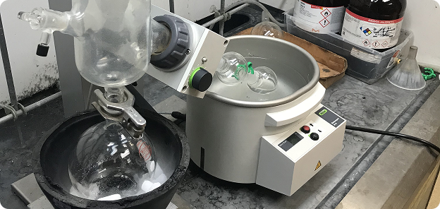 A rotary evaporator with a dry ice condensor being used to remove solvent from a 100 mL round bottom.